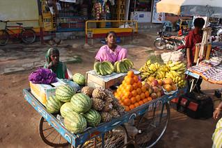 A bustling local farmers market with vendors selling fresh produce and interacting with customers, showcasing the economic impact of the farm-to-table movement.