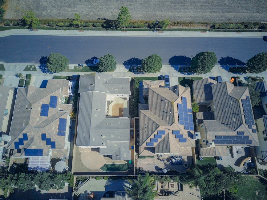 Solar panels on the roofs of multiple suburban houses